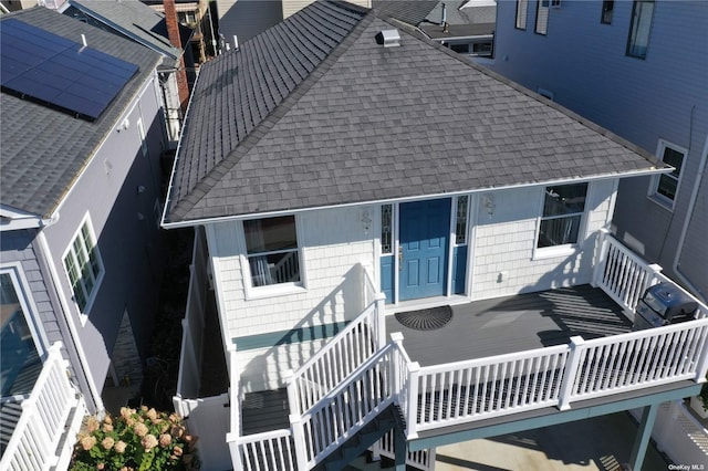 74 Wisconsin St, Long Beach, NY 11561 - rear view of house with stairs and a shingled roof