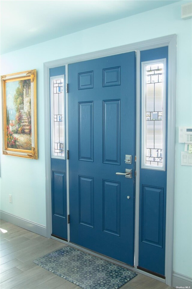 74 Wisconsin St, Long Beach, NY 11561 - entryway featuring visible vents, light wood-style flooring, and baseboards