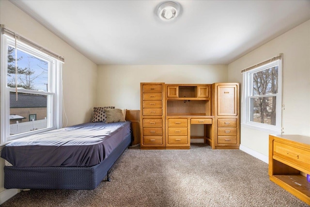 carpeted bedroom featuring baseboards