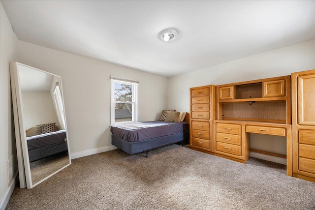 bedroom with light carpet and baseboards