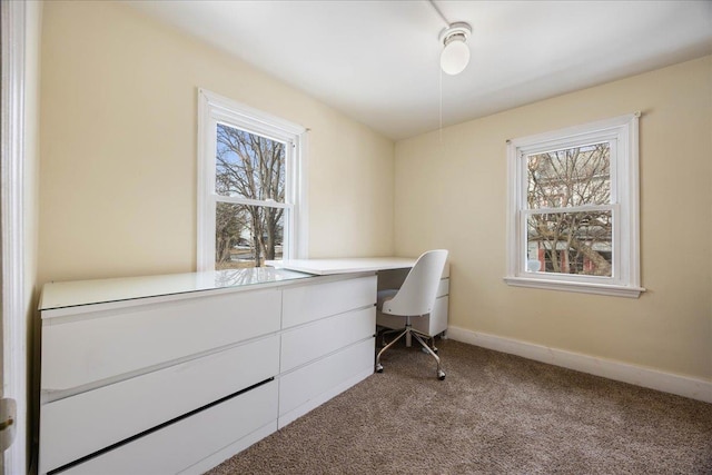 office with carpet floors, plenty of natural light, baseboards, and built in study area