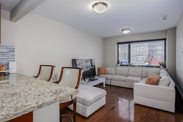 living room featuring visible vents and dark wood-type flooring