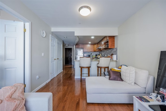 living area with wood finished floors and baseboards