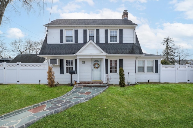 dutch colonial featuring a gate, a front lawn, and roof with shingles