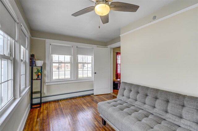 unfurnished room featuring a baseboard radiator, ceiling fan, and hardwood / wood-style flooring