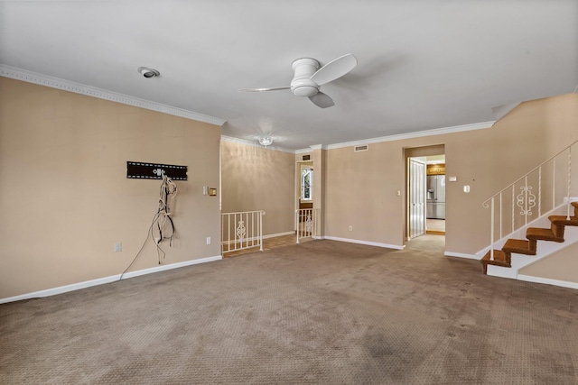 unfurnished living room with ceiling fan, visible vents, baseboards, carpet, and crown molding