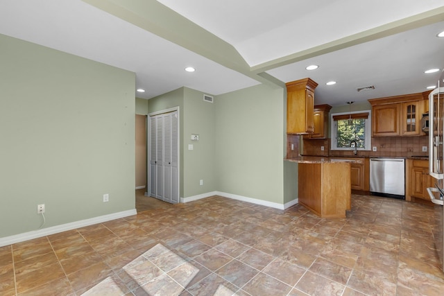 kitchen featuring baseboards, tasteful backsplash, visible vents, and stainless steel dishwasher