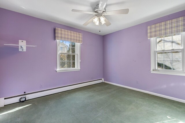 carpeted empty room featuring a ceiling fan, a baseboard radiator, and baseboards