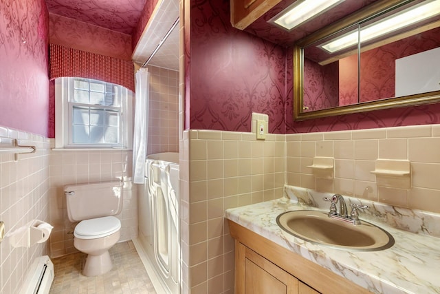 bathroom with toilet, curtained shower, a baseboard heating unit, and wainscoting