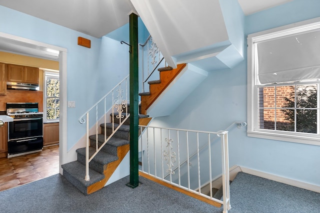 staircase featuring baseboards