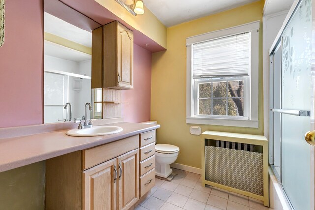 full bath with toilet, radiator heating unit, a shower with shower door, vanity, and tile patterned flooring