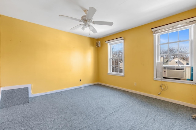 carpeted empty room with cooling unit, a ceiling fan, and baseboards