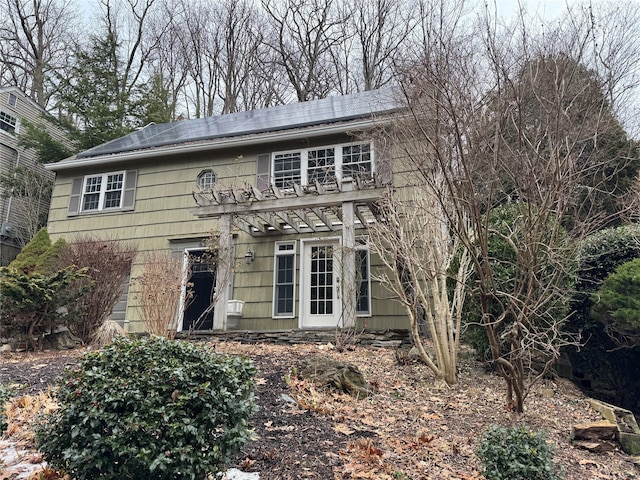 colonial-style house with roof mounted solar panels