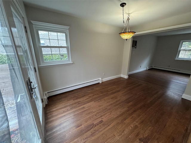 interior space featuring a baseboard heating unit, baseboard heating, dark wood-style floors, and baseboards