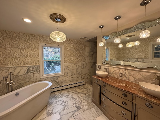 full bathroom featuring marble finish floor, tile walls, baseboard heating, and a sink