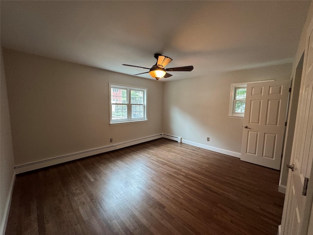 spare room with dark wood-style floors, a baseboard radiator, baseboards, and ceiling fan