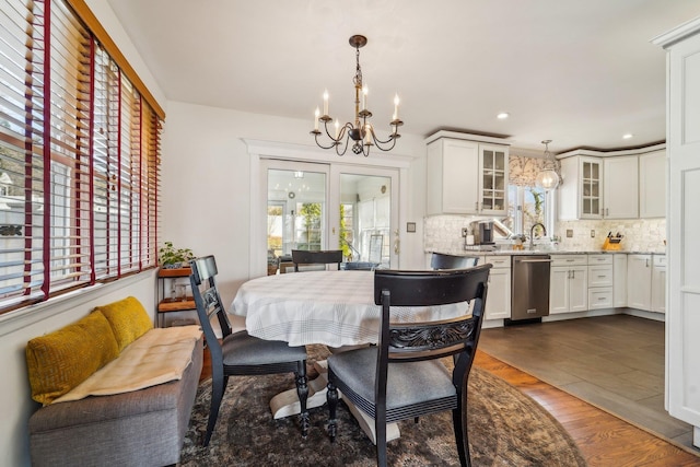 dining space with a notable chandelier, dark wood-style flooring, and recessed lighting