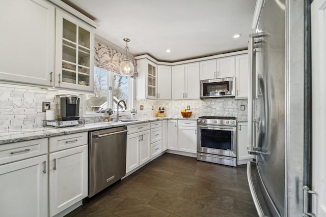 kitchen featuring stainless steel appliances, tasteful backsplash, and a sink