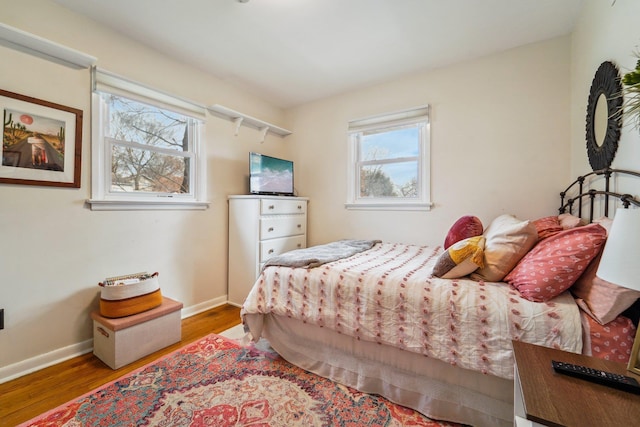 bedroom featuring baseboards and wood finished floors