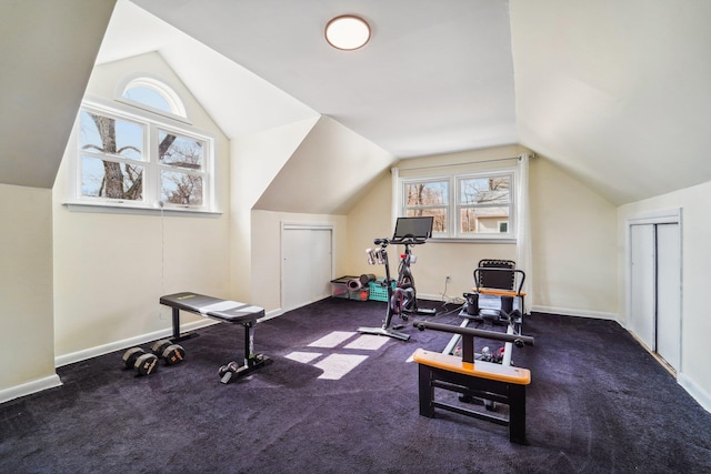 workout area with lofted ceiling and baseboards