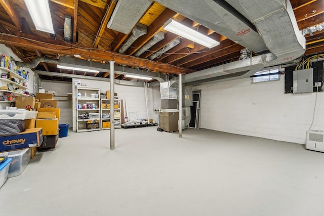 basement featuring heating unit and electric panel