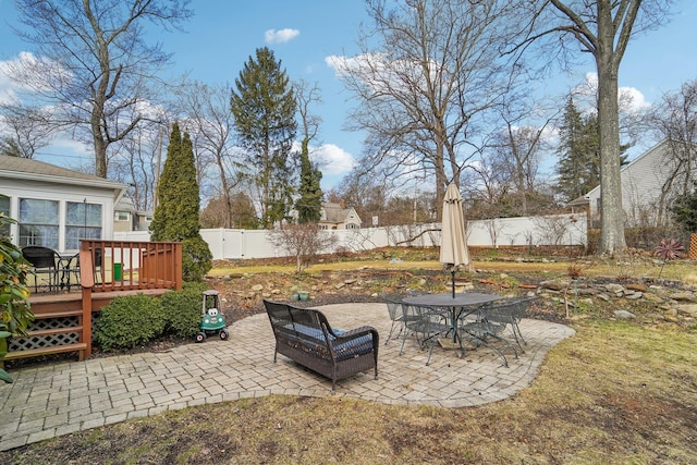 view of yard with a deck, a patio area, and a fenced backyard