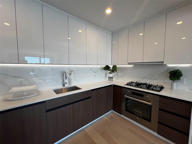 144-49 Northern Blvd Unit 213, Flushing, NY 11354 - kitchen featuring stainless steel appliances, modern cabinets, a sink, light wood finished floors, and white cabinetry