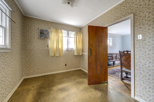 unfurnished room featuring a wealth of natural light, crown molding, and wallpapered walls