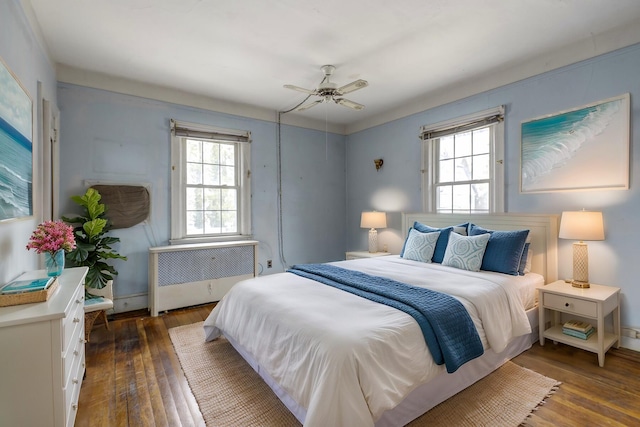 bedroom featuring ceiling fan, hardwood / wood-style floors, and radiator heating unit