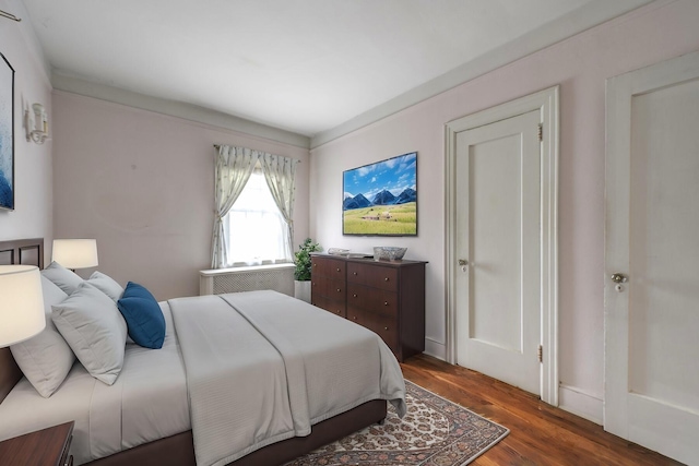 bedroom with dark wood-style flooring