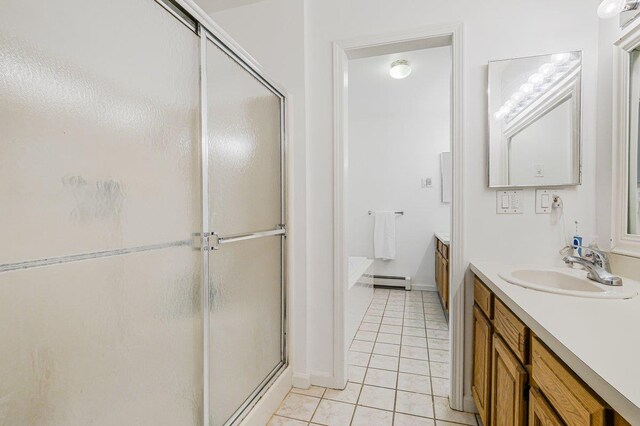 full bath with a baseboard heating unit, a stall shower, vanity, and tile patterned floors