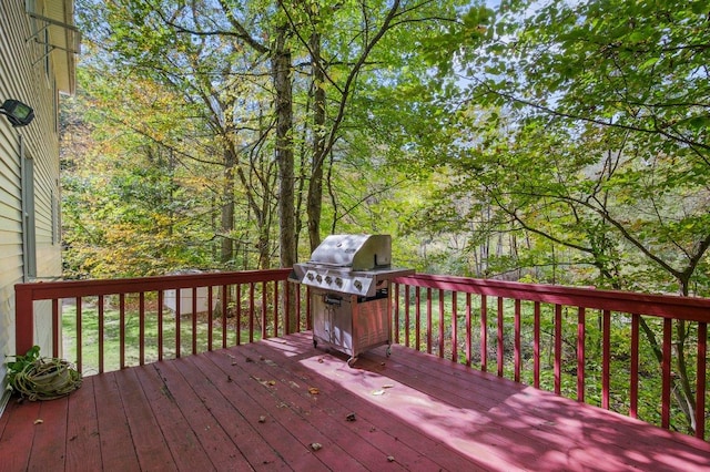 wooden deck featuring a grill