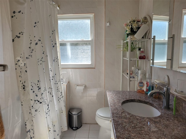 full bath featuring plenty of natural light, tile walls, toilet, and tile patterned floors