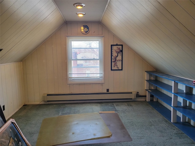 additional living space featuring a baseboard heating unit, carpet floors, wood walls, and lofted ceiling