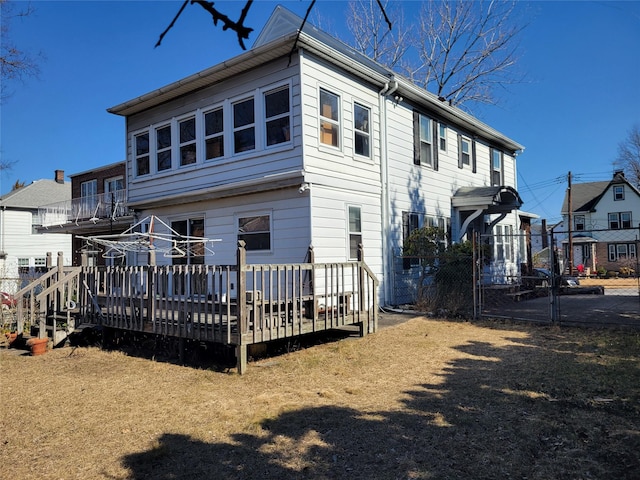 back of house with a wooden deck