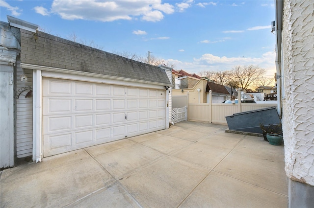 detached garage featuring fence