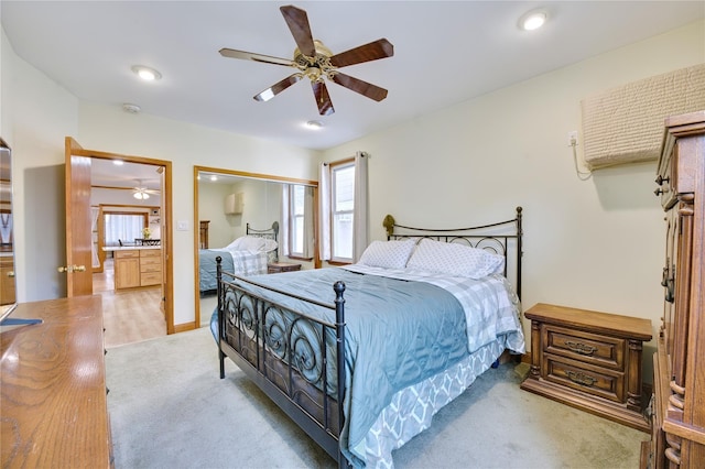 bedroom featuring light carpet, ceiling fan, and a closet