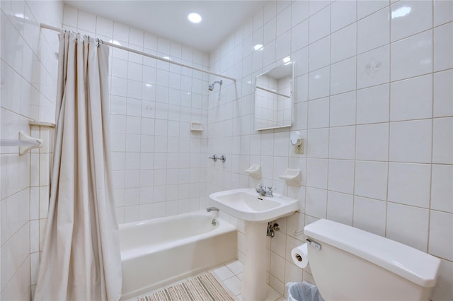 full bath featuring toilet, shower / bath combination with curtain, tile walls, and tile patterned floors