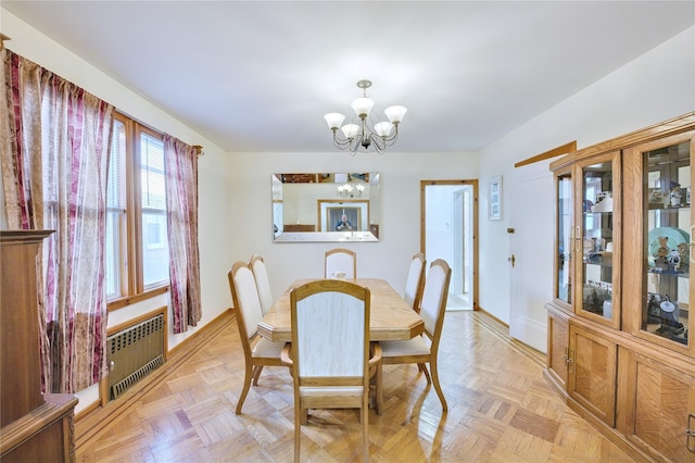 dining room with radiator heating unit and a notable chandelier