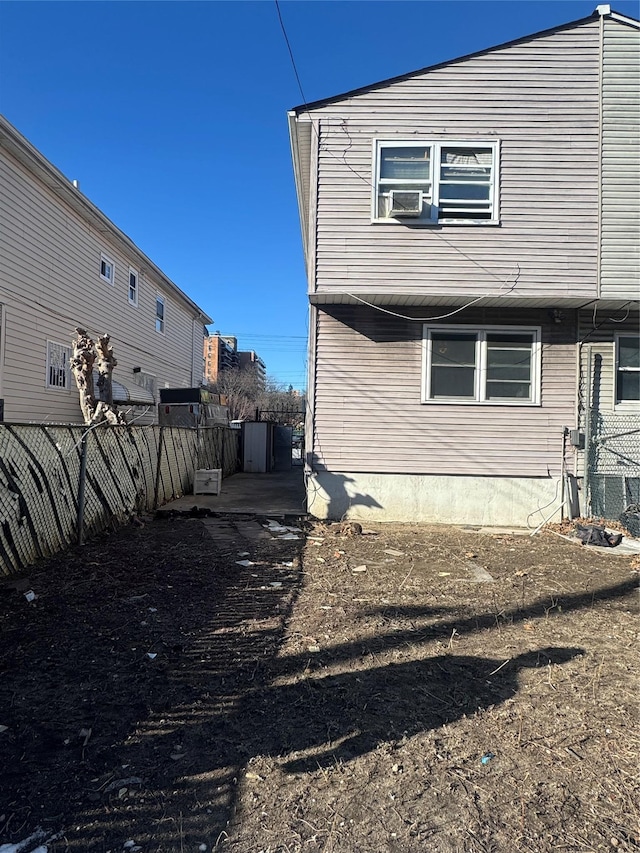 rear view of property featuring fence