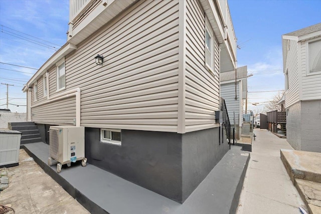 view of side of home featuring ac unit