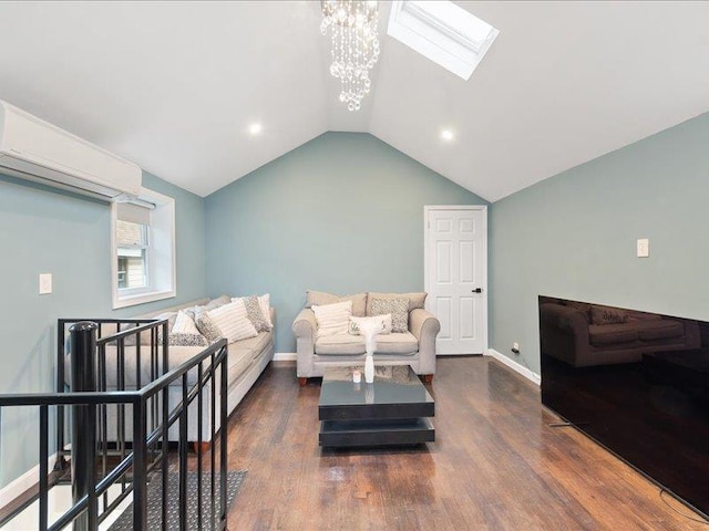 living room featuring a notable chandelier, vaulted ceiling with skylight, wood finished floors, and baseboards