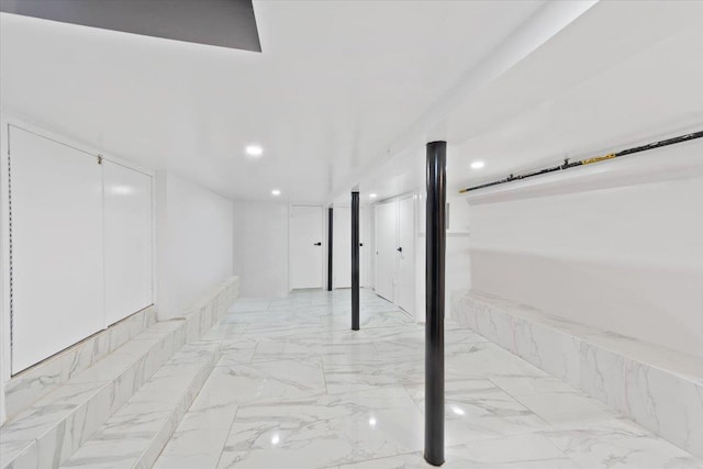 finished basement featuring marble finish floor and recessed lighting