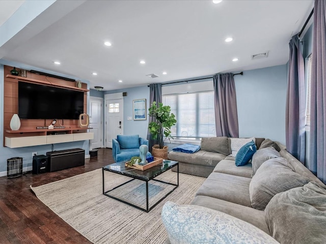 living area with visible vents, wood finished floors, and recessed lighting