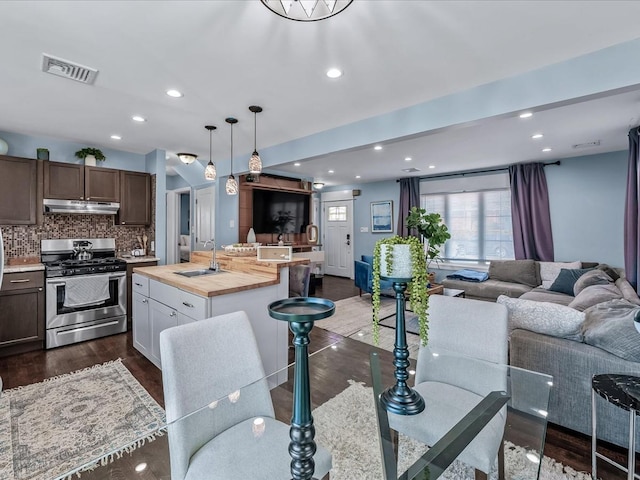 dining area with visible vents, dark wood finished floors, and recessed lighting