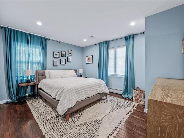 bedroom with recessed lighting and dark wood finished floors