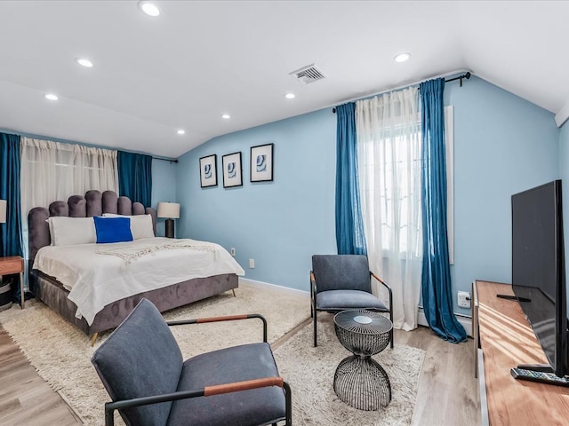 bedroom featuring vaulted ceiling, wood finished floors, visible vents, and recessed lighting