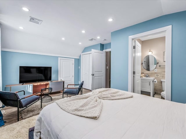 bedroom featuring recessed lighting, visible vents, connected bathroom, and tile walls