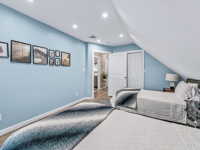 bedroom featuring baseboards, visible vents, wood finished floors, and recessed lighting