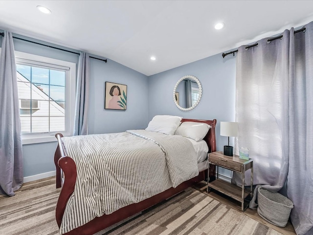 bedroom with baseboards, vaulted ceiling, wood finished floors, and recessed lighting